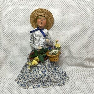 Byers Choice Ltd.  The Carolers doll with baskets of flowers. 2005.
